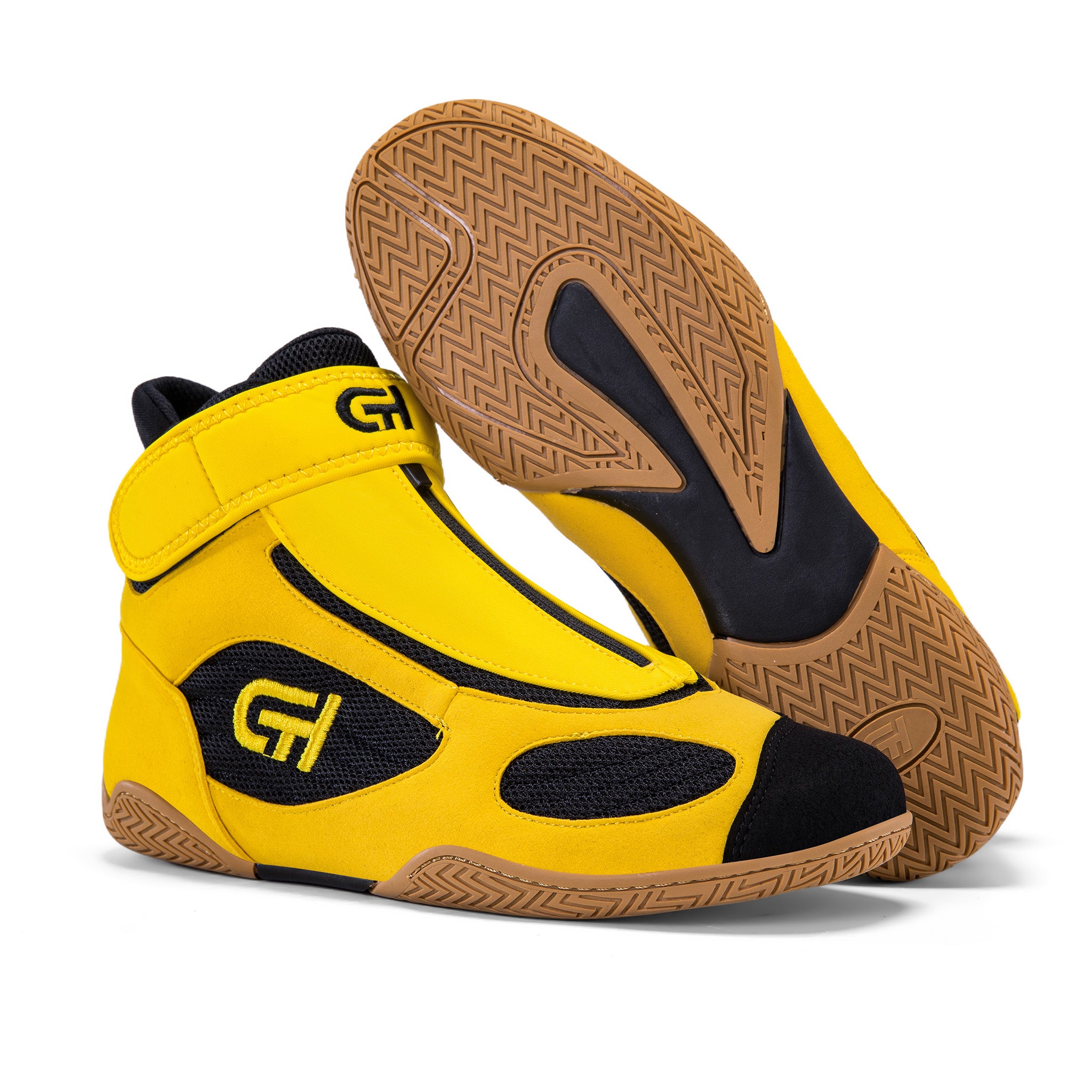 Yellow and black high-top wrestling shoes with tan patterned soles, featuring “CH Gear” branding, shown together with one shoe lifted to display the sole.