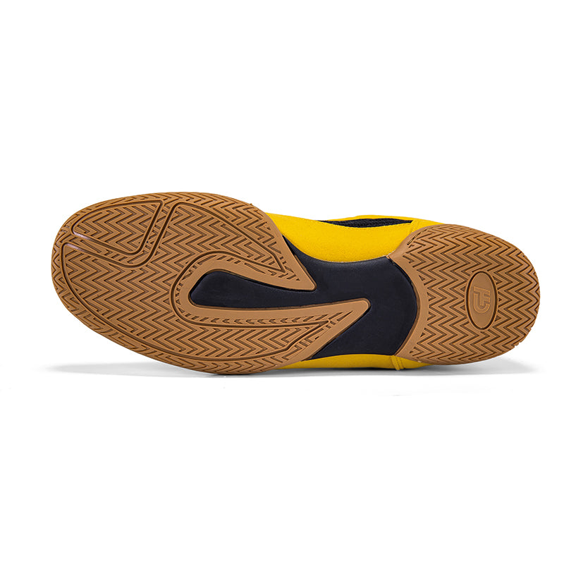 The outsole of a ch gear wrestling shoe shown from a top-down view, featuring a textured brown herringbone-patterned rubber with a black central accent and a bright yellow heel and forefoot section.