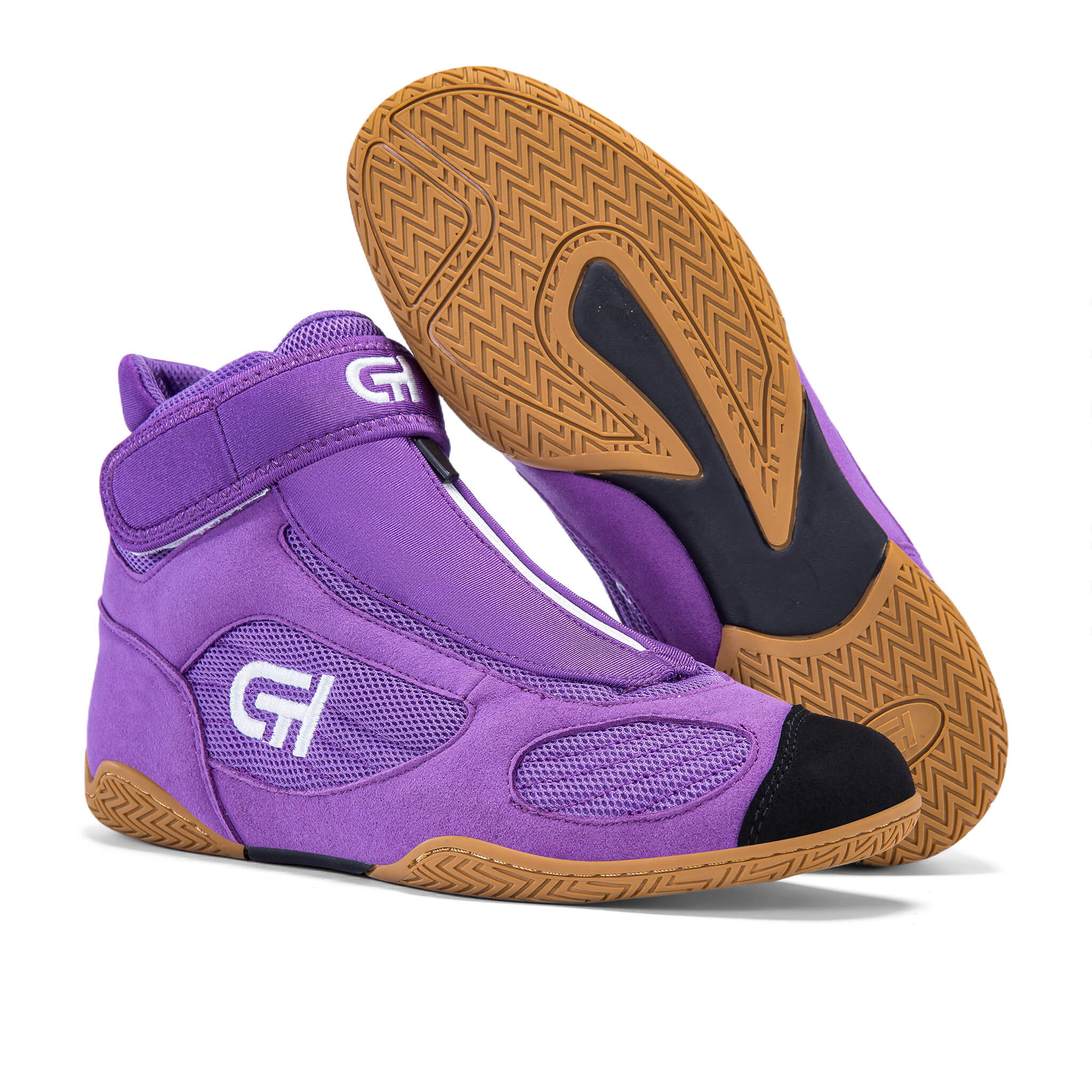 A pair of purple high-top ch gear wrestling shoes shown on a white background, with one shoe standing upright and the other tilted to display the brown textured outsole.