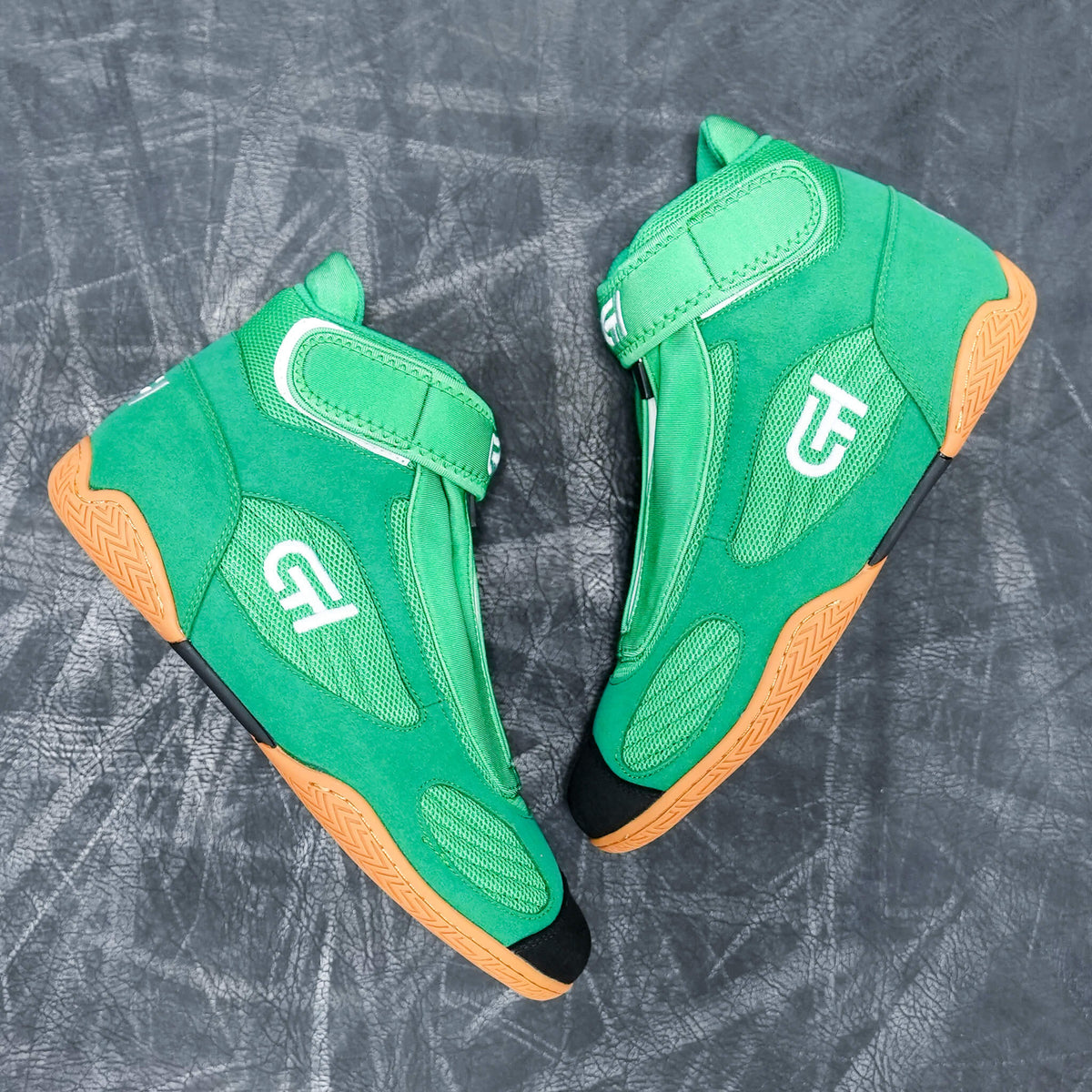 A pair of green high-top CH Gear XXVI Lucky Shoes with orange soles and white logo details, displayed on a textured gray background.